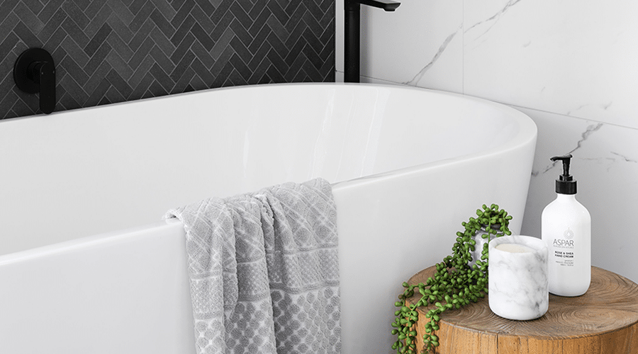 Add fancy soaps, candles, and even greenery to bathrooms to make them feel cozy