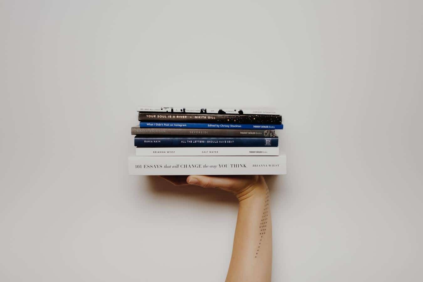 holding pile of books