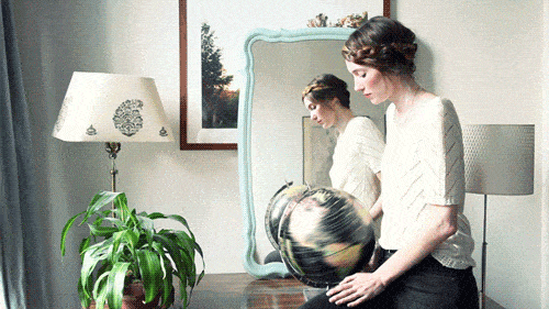 woman spinning the globe gif