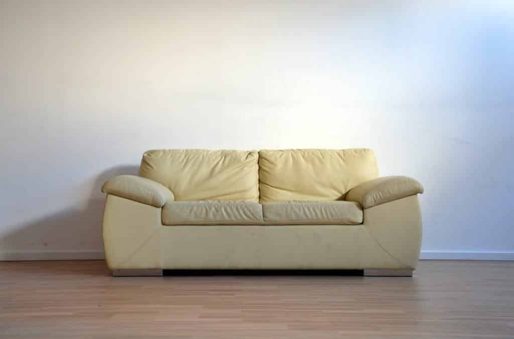 yellow couch in an empty room