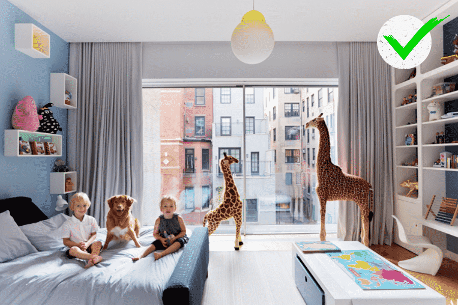 Kids' bedroom showing two kids, a dog and two giraffe toys