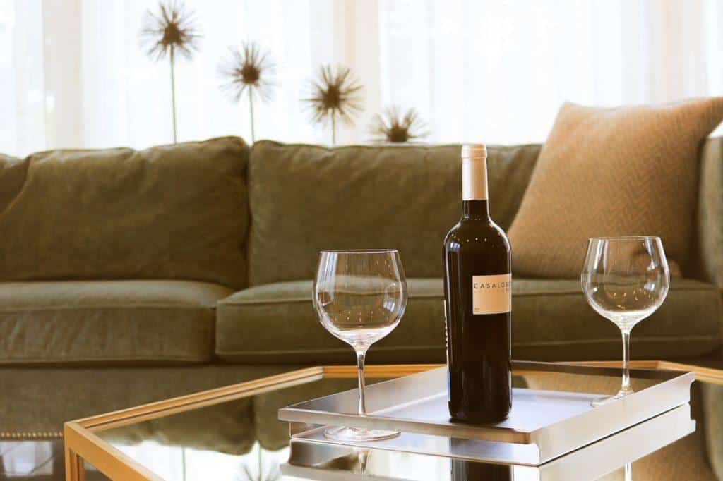 a bottle of wine with two wine glasses in the living room