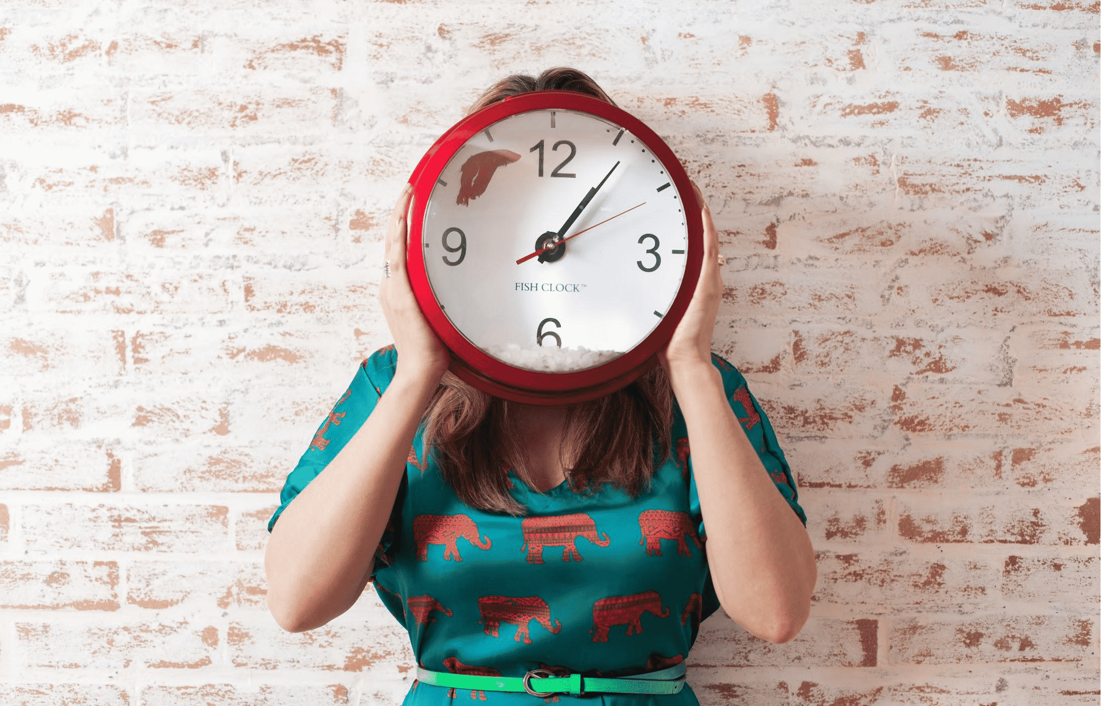 Woman holding a wall clock