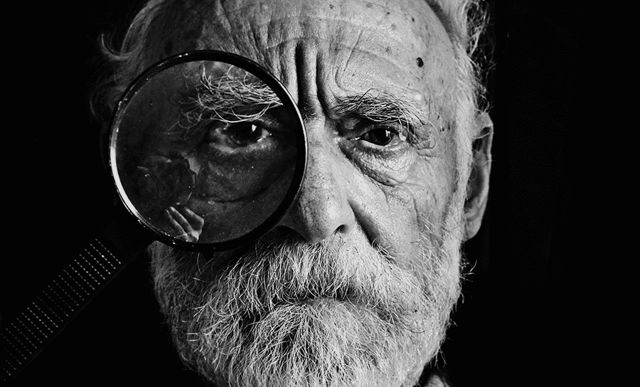 Old man with magnifying glass