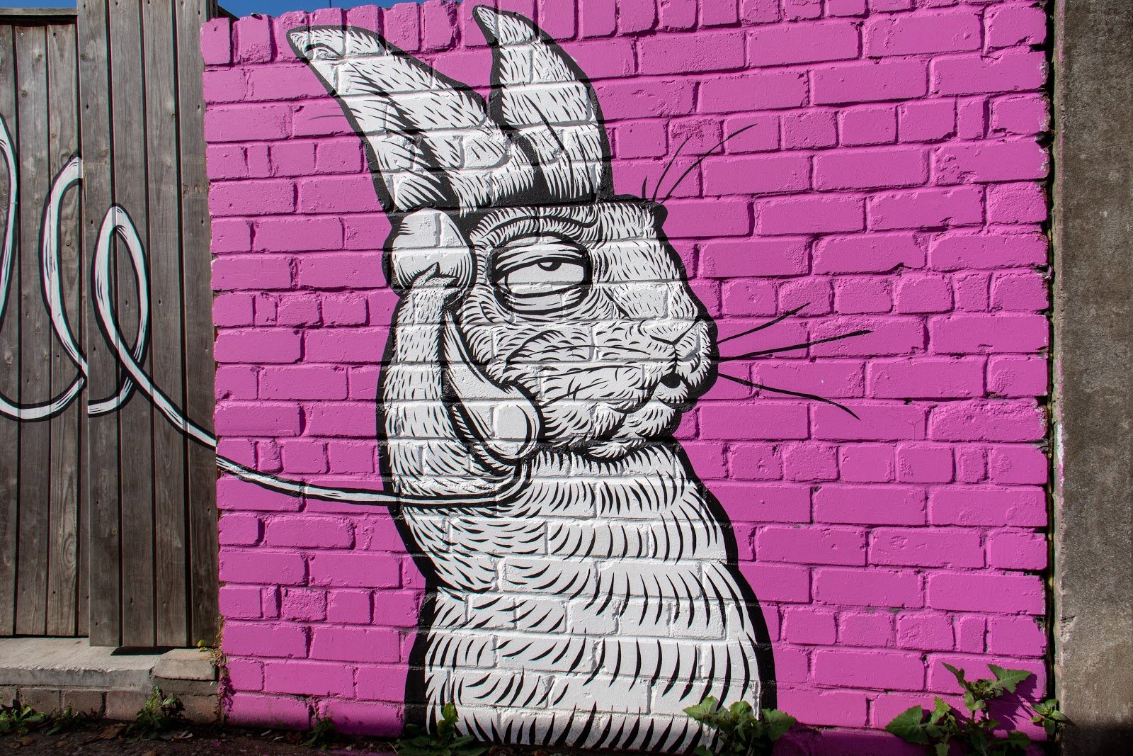 Mural on a brick wall of a rabbit calling
