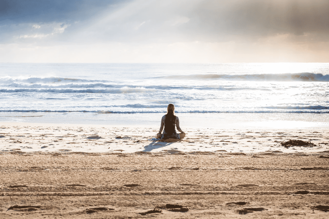 Woman Meditating at the Beach