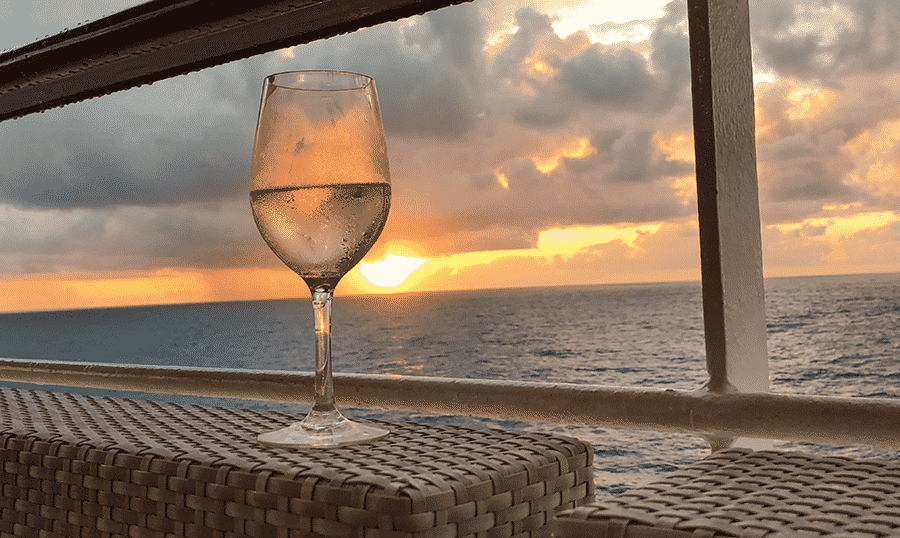 A glass of sparkling rose at a sunset