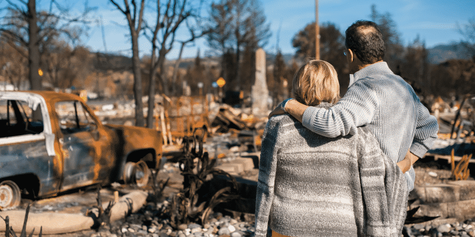 couple seeing the aftermath of bushfire