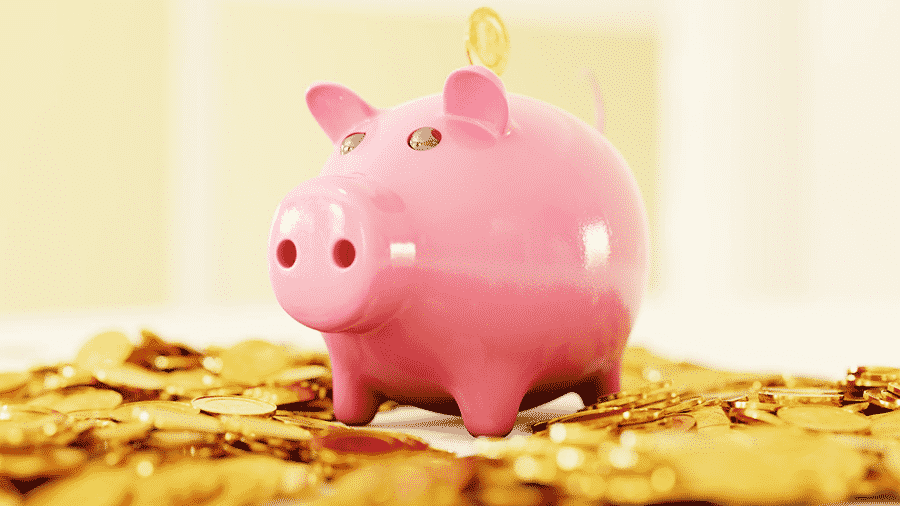 piggy bank with coins around it
