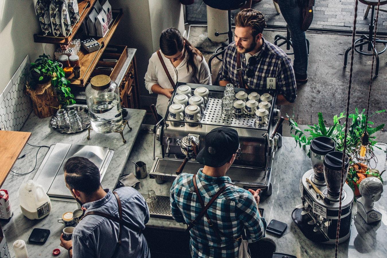 Overhead view of a coffee shop with people waiting for their coffee order
