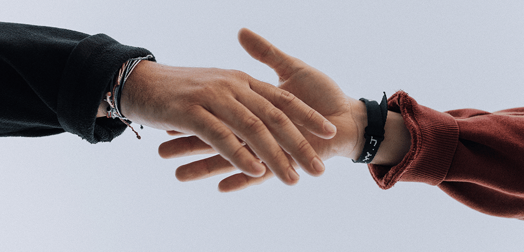 A man and a woman's hands in a handshake