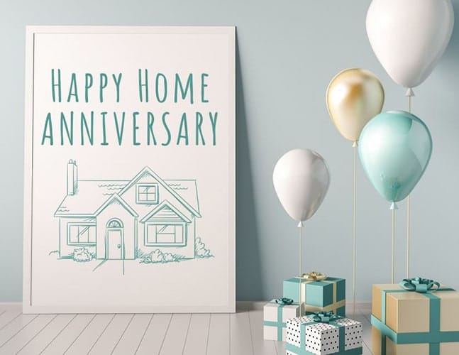 presents and balloons surround a framed drawing of a house that reads Happy Home Anniversary