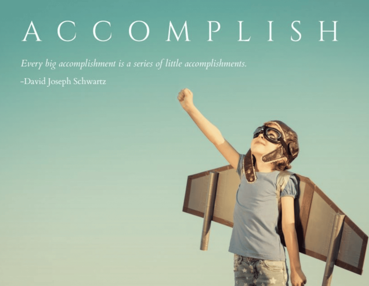 a girl with old fashioned aviator googles and cardboard wings stares up at the sky with her fist triumphantyly in the air, with text that reads "accomplish"