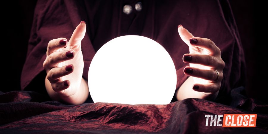 A woman fortune teller's hands around a glowing ball