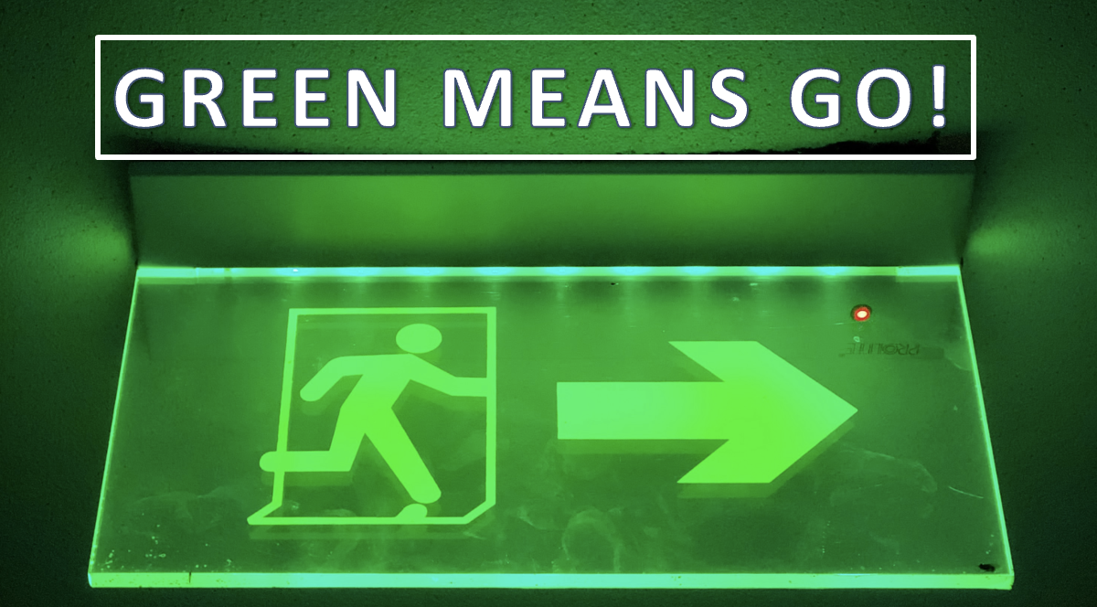 Green sign indicating pedestrian exit opportunity, with the words "green means go!" on top