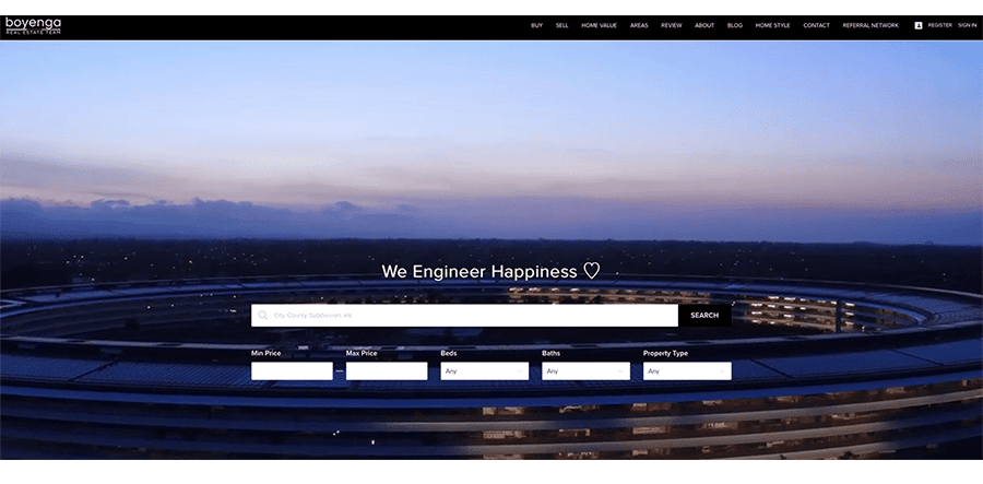 real estate website example with an image of what looks like the Apple headquarters and reads "we engineer happiness"