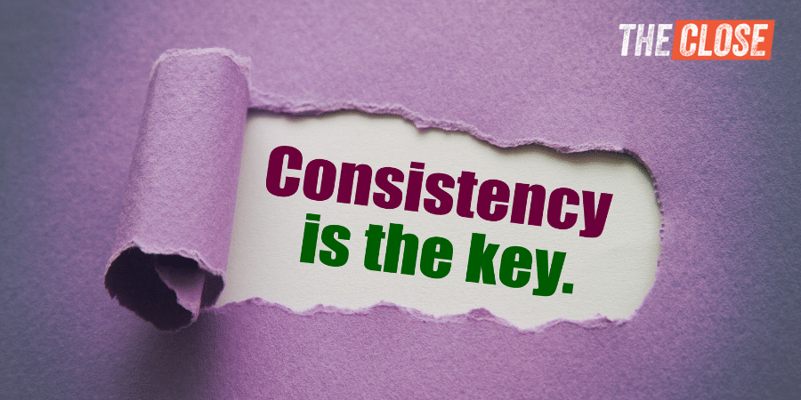 "Consistency is the key" typed on a piece of paper.