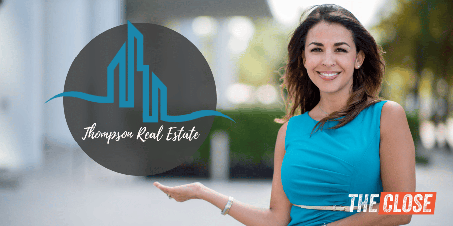 real estate agent smiling with a real estate logo