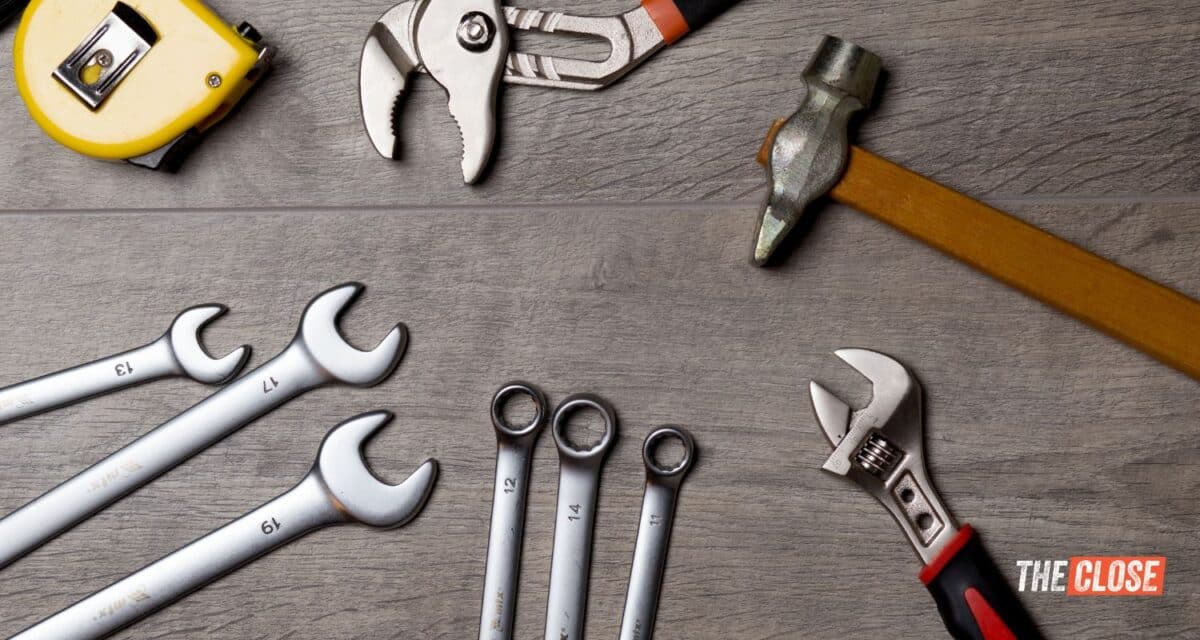 a variety of tools laying out on a grey wood background with The Close's logo in the lower right hand corner