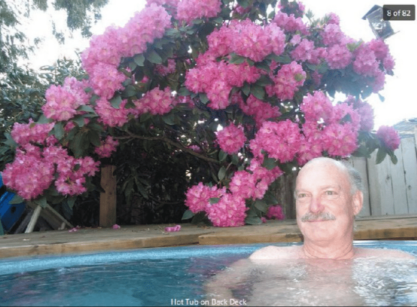 screenshot of a zillow listing with a man in a hot tub