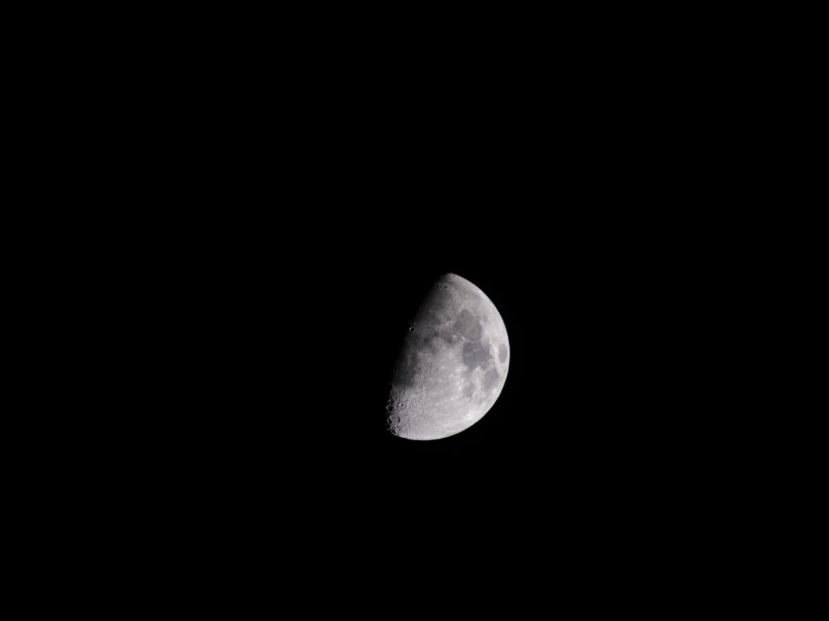 Partial image of quarter moon in dark sky