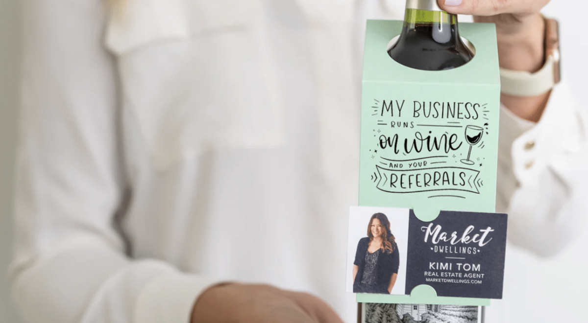 11. Bottle of Wine with a card that reads 'My Business Runs on Wine & Your Referrals' on it
