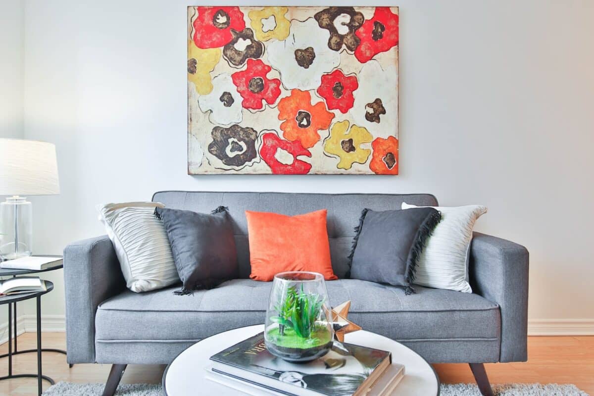 Couch with bright art behind and a coffee table in front