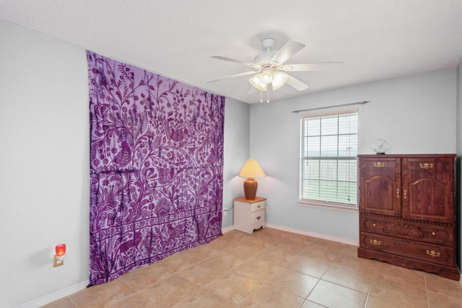 My photographer used virtual staging techniques to change this purple bedroom to light gray.