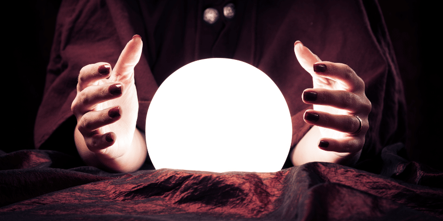 Glowing orb with a woman fortune teller's hands held around it.