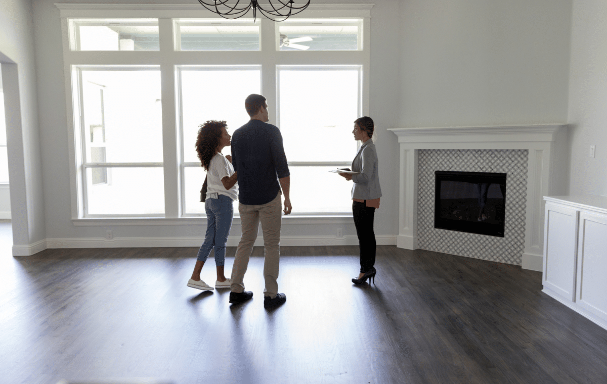 Real estate agent showing a couple a vacant home.