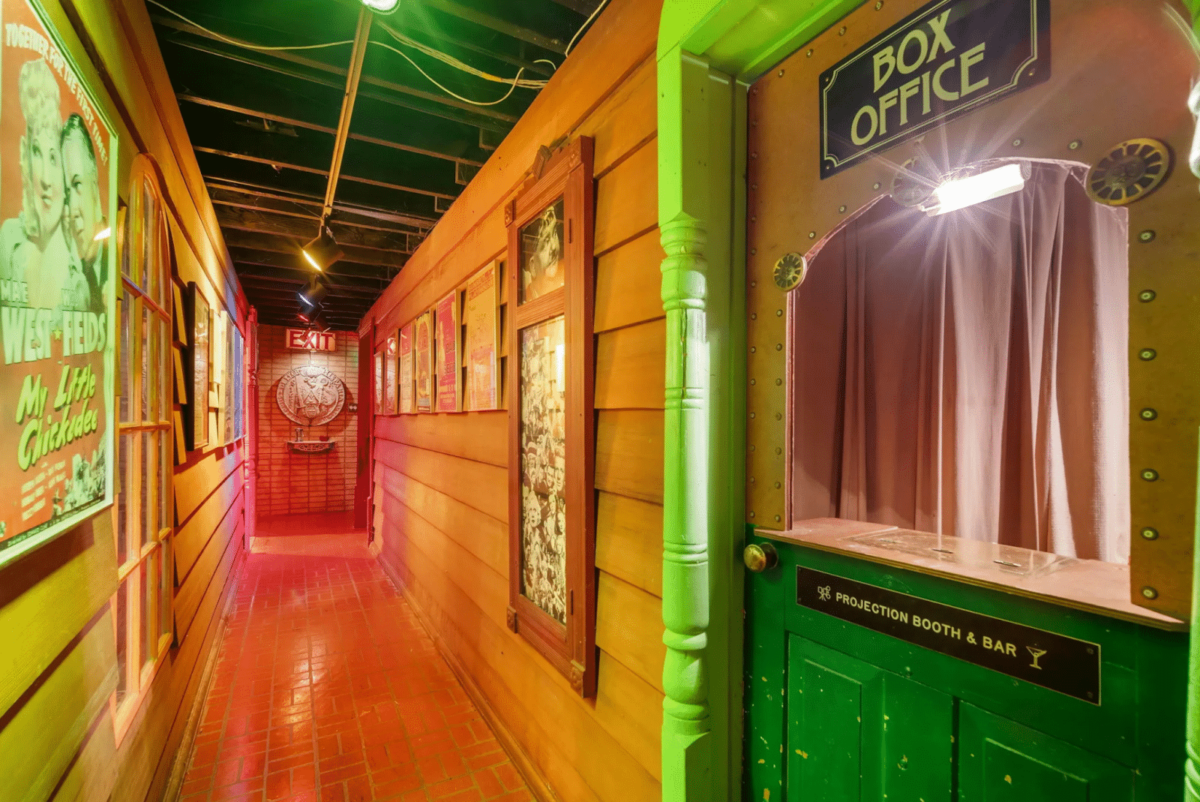 A colorful hallway with a projection booth and a bar