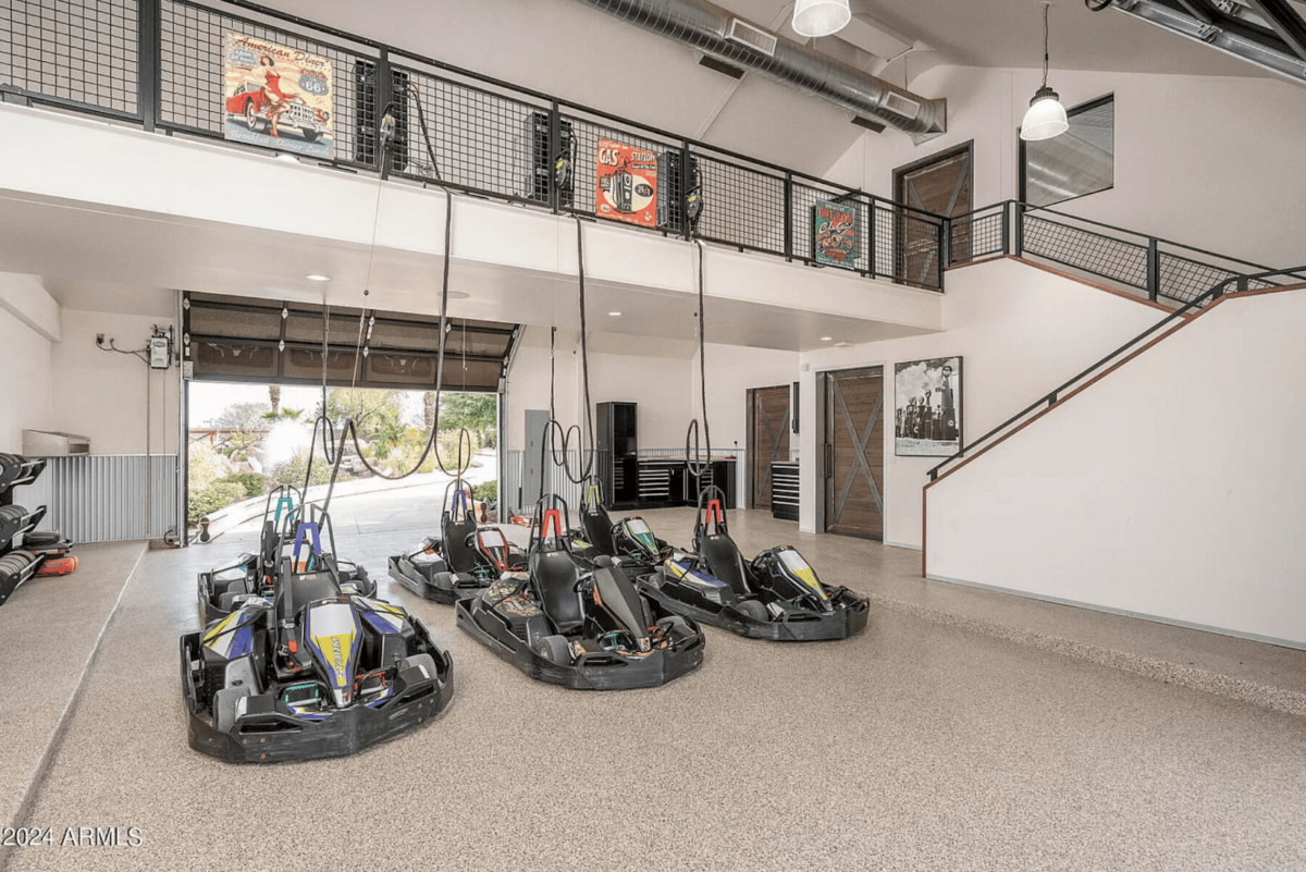 Six Go-Karts parked inside a huge garage