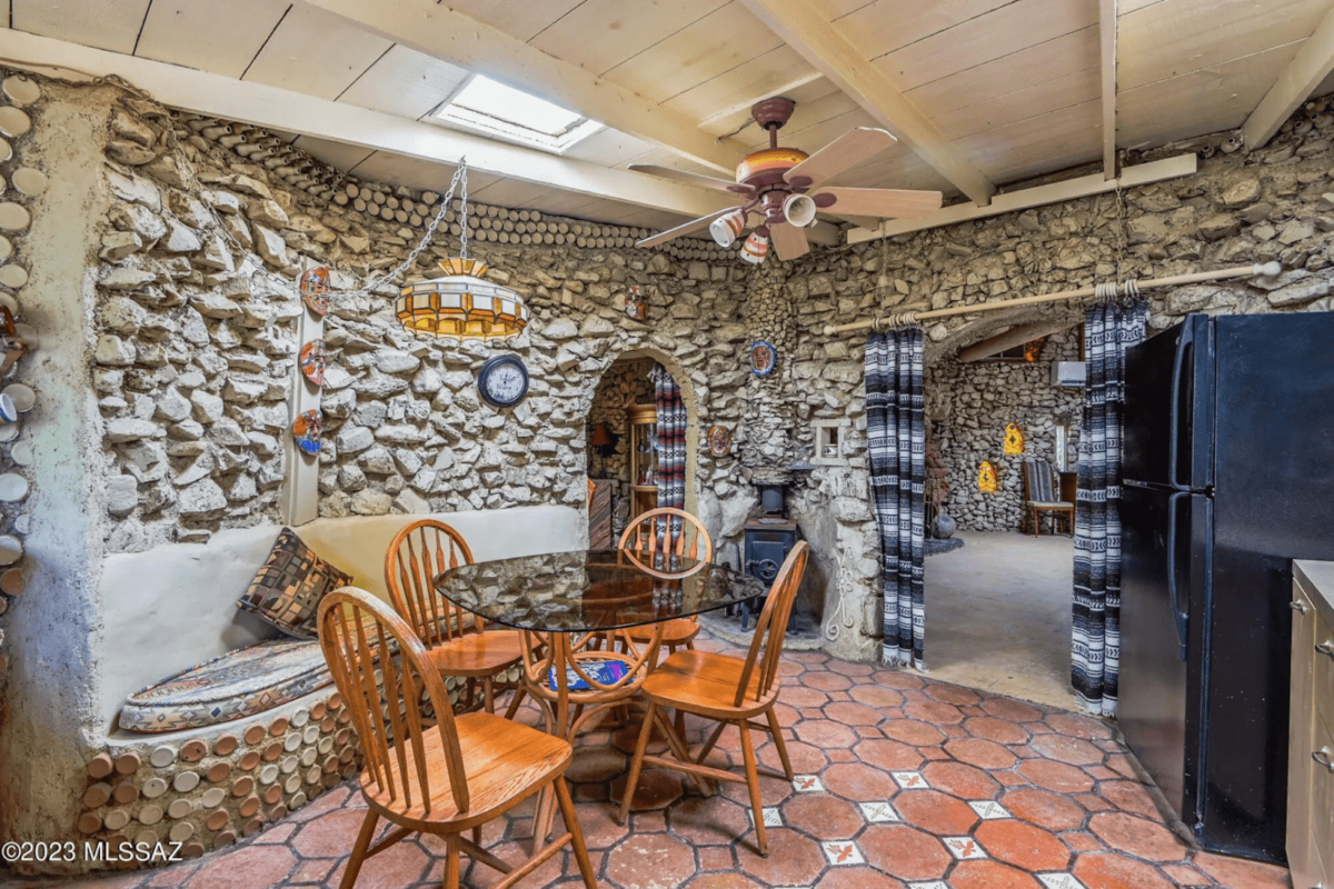 A dining room with walls made of rocks