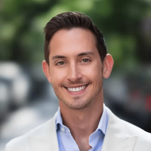 A male real estate agent's smiling headshot