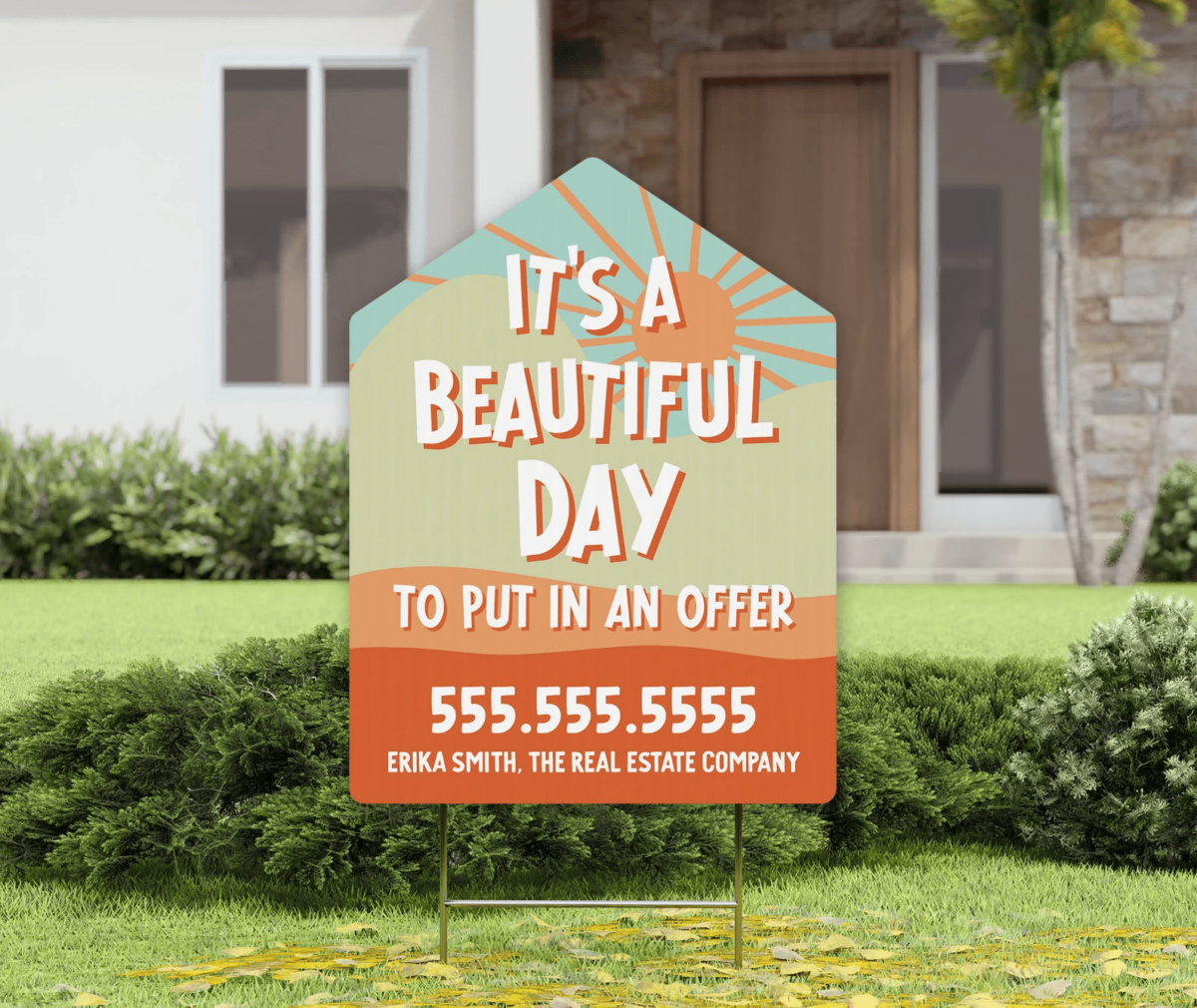 A bright-colored real estate sign with "It's a beautiful day to put in an offer" printed using a modern font on it