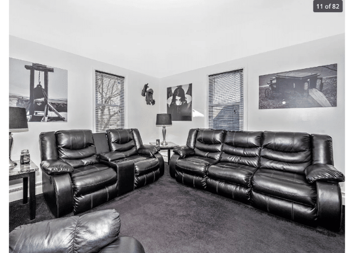 Living room with black accents and creepy photos