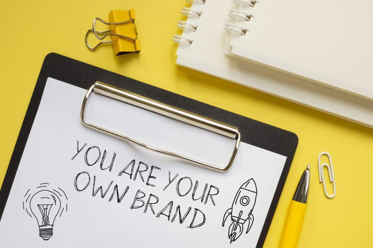 Clipboard with paper that says, "You are your own brand." 